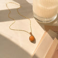 Orange Gemstone Necklace for Women Elegant Gold Chain Necklace with Orange Oval Pendant and Sparkling Halo Design for Women