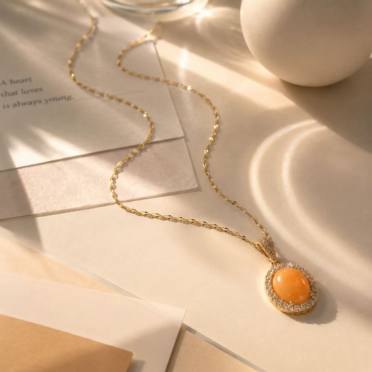 Orange Gemstone Necklace for Women Elegant Gold Chain Necklace with Orange Oval Pendant and Sparkling Halo Design for Women